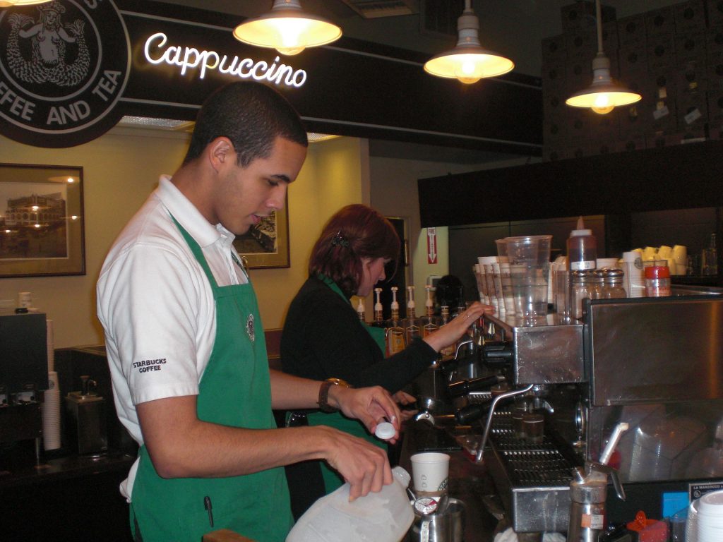 Starbucks employees prepare coffee.
